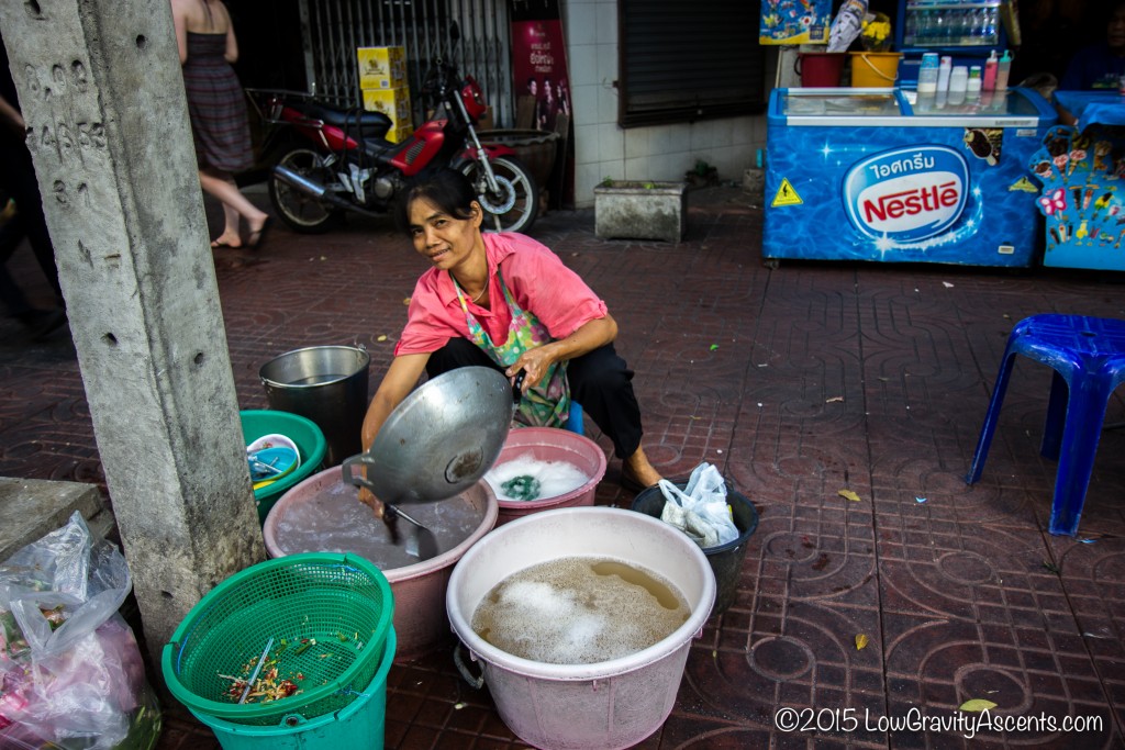 Thailand Street Vendor Doing Dishes
